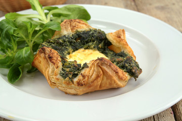 puff pastry with goat cheese and spinach on a plate