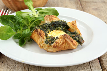puff pastry with goat cheese and spinach on a plate
