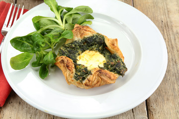 puff pastry with goat cheese and spinach on a plate