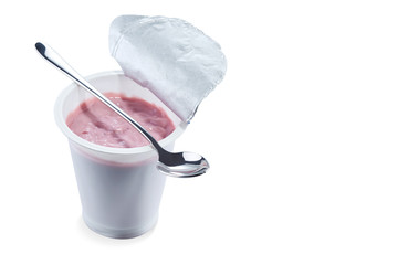 Yoghurt flavored cherry in an open plastic Cup with a beautiful elegant spoon isolated on a white background.