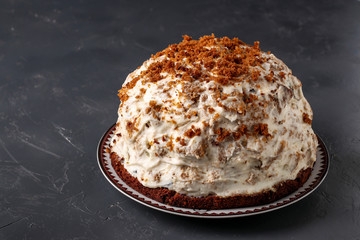 Pancho Cake with Sour Cream, Walnuts, Prunes and Chocolate on dark background