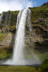 Fototapeta na wymiar Seljalandsfoss Waterfall in Iceland. A famous waterfall with a path to walk behind the falls.