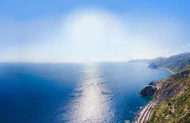 Fototapeta premium Aerial view from distance, general view of the area Manarola Villages of National Park. railroad station. Province of La Spezia, Liguria, Beautiful mountain north of Italy. Copy space background.