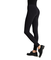 Woman wear black blank leggings mockup, isolated, clipping path. Women in clear leggins template. Cloth pants design presentation. Sport pantaloons stretch tights model wearing. Slim legs in apparel