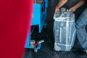 Luggage wrapping service at the airport terminal for security reason and safety protection from...
