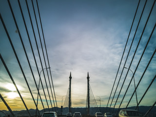 Obraz premium Towers of Bridge connecting George Town on Penang island and Seberang Prai on mainland of Malaysia through straits of Malacca.