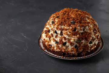 Pancho Cake with Sour Cream, Walnuts, Prunes and Chocolate on dark background, Copy space