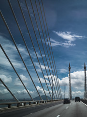 Obraz premium Towers of Bridge connecting George Town on Penang island and Seberang Prai on mainland of Malaysia through straits of Malacca.