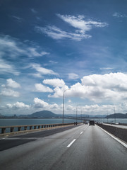 Fototapeta premium Towers of Bridge connecting George Town on Penang island and Seberang Prai on mainland of Malaysia through straits of Malacca.