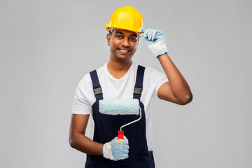 repair, construction and building - happy smiling indian builder or painter in helmet with paint...