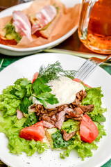 Fresh vegetable salad cucumbers, tomatoes on a white plate