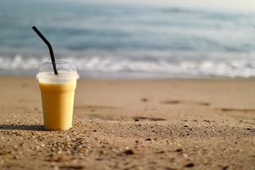 A yellow smoothie on the beach