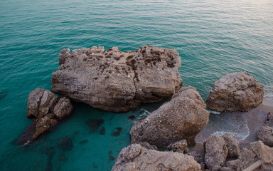 View of rocks in the beach of Nerja. White Village in Malaga, Andalusia, Spain from the Balcony of Europe
