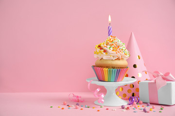 Composition with birthday cupcake on pink background. Space for text