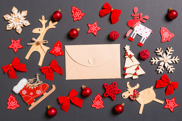 Christmas black background with holiday toys and decorations. Top view of craft envelope. Happy New Year concept
