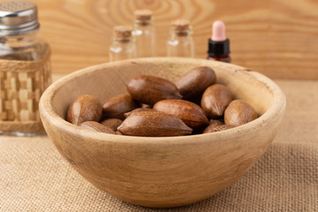 wooden bowl with pecan nuts in a rustic environment. Concept of the benefits of pecan oil on health