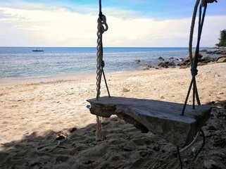 Wooden swing under tree at Ao Sane beach, beautiful and relaxed destination in Phuket, Thailand