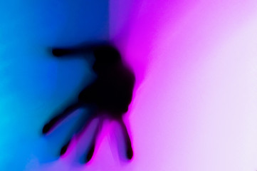 Hands in blue and pink neon light gradient behind white surface. Foggy blurred effect for different concept ideas. Trendy duotone illumination.