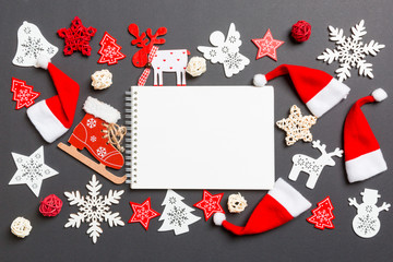 Top view of notebook. New Year decorations on black background. Merry Christmas concept