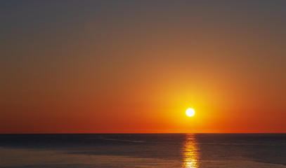 Dawn over the sea, a wonderful sun rises over the horizon.