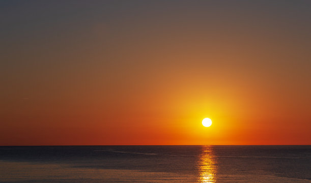 Dawn over the sea, a wonderful sun rises over the horizon. © Alexander