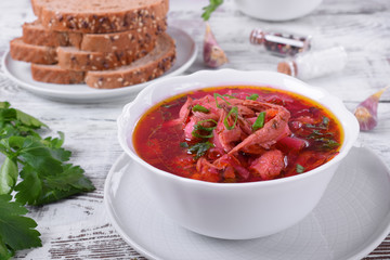 Borscht soup with meat in a white bowl. Ukrainian cuisine meal