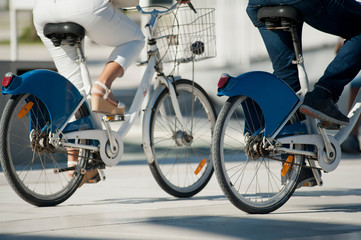 advertising support in fender bicycle man and woman pedaling on street seaport