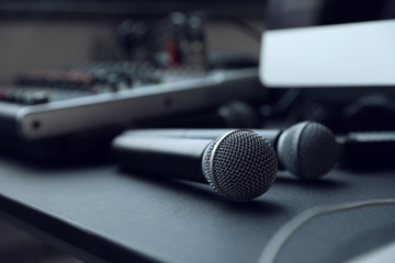 Modern microphone on black table indoors, closeup