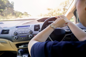 Female hands on the steering wheel of a car. Woman hands holding a steering wheel confidently.