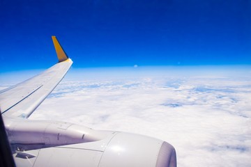 blue sky and white clouds by plane window 