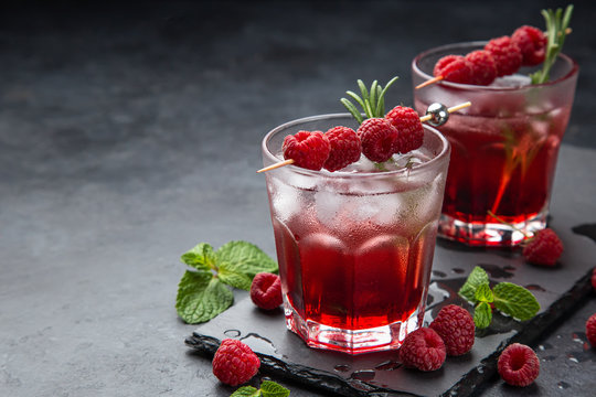 raspberry cocktail with ice and fresh berry
