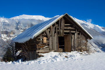 Fototapeta premium Snow-covered chalet in the Swiss Alps