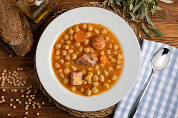 Chickpea stew dish (potage - cocido madrileño). With beef, sausage (chorizo), bacon, carrots and...
