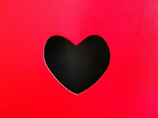 Black heart on a red background