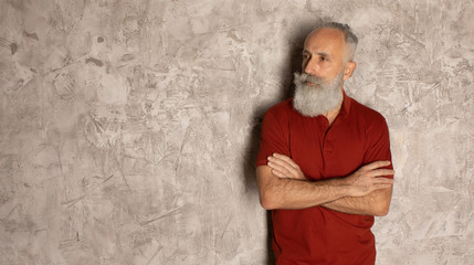 Perfect beard. Close-up of senior bearded man standing against grey background.