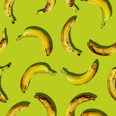 Colorful creative seamless fruit pattern set of organic ugly ripe fruit bananas on green color...