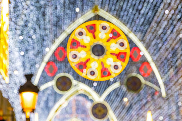 Blurred illuminated bokeh of the lights of New Year and Christmas decorations of Calle Marques de Larios street in the centre of Malaga city, Andalusia, Spain