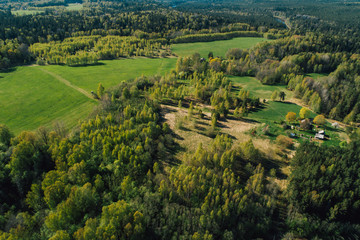 Fototapeta na wymiar Aerial view on rural forest area with small road 
