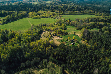 Aerial view on rural forest area with small road 