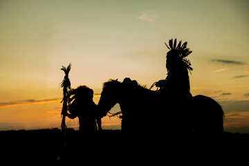 The Indians are riding a horse and spear ready to use In light of the Silhouette