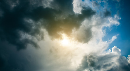 Fototapeta na wymiar Beautiful fluffy rain clouds in the blue dramatic sky. Bad weather.