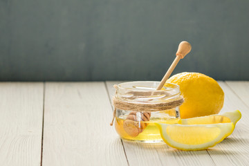 lemon and honey on wooden backgrond with copy spice