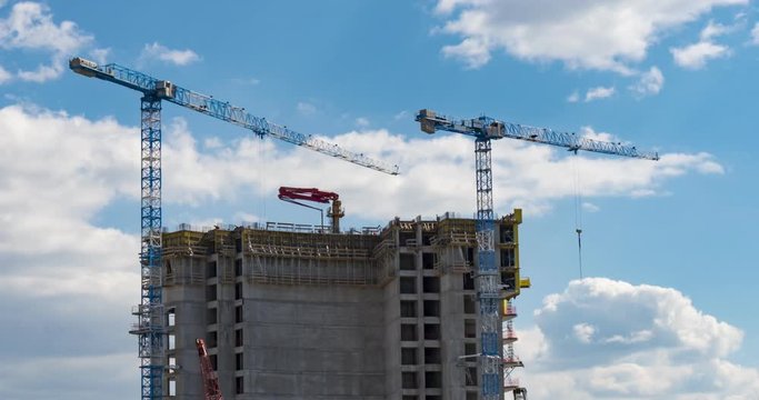 Building Skyscraper With Workers and Crane on the Roof with Blue Sky Time lapse.
