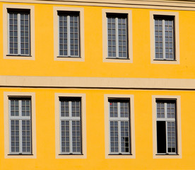 A yellow walled building with windows
