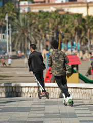 two electric scooter running for ride young boys