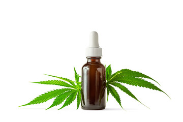 Glass Bottle of CBD or THC Oil with Hemp or Medical Cannabis Plant Leaves Isolated on White...