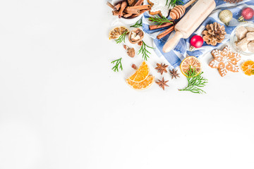 Christmas baking background. Christmas sweet cooking ingredients on white table. Ingredient for cooking christmas pastry, cookies and cakes, Flatlay on white table, top view with copy space