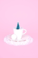 Creative Christmas design on pink pastel color background with Christmas tree.