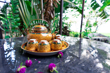 Antique Benjarong porcelain golden tea set on Stone table , ceramics porcelain