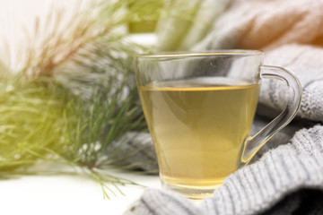 Cup of tea with a cozy wool background. Winter mood morning in a comfortable and warm atmosphere. Green tea for relaxation and positive moments.
